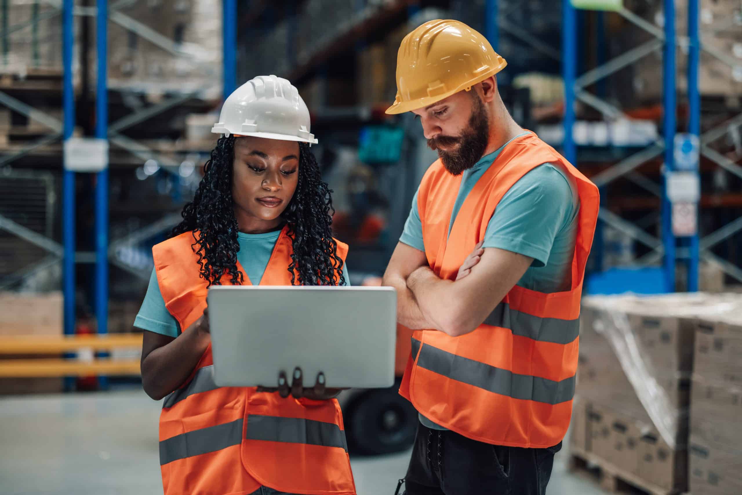 Construction Workers Concentrating on Laptop