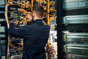 Man Working on Networking Equipment